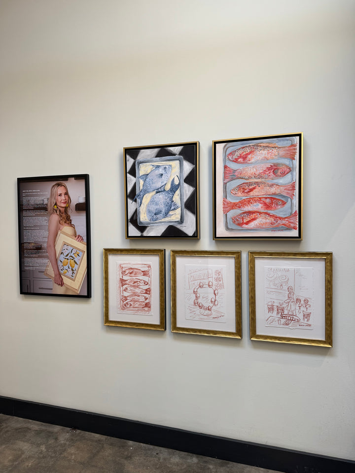 A Gallery wall of pieces from Southern Artist Arden Upton's Frank's Table Collection featuring her Red Fish oil painting, her blue fish painting, the redfish sketch, farm fresh eggs sketch, and a sketch from in the restaurant accompanied by the biography and information on Arden herself.