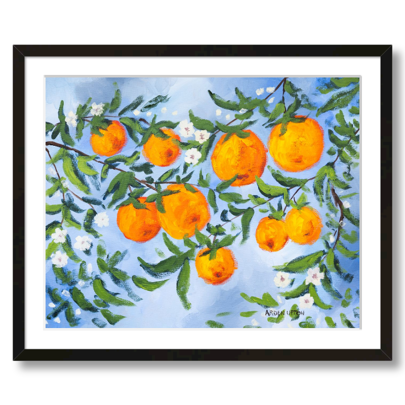 A ready to hang, framed giclee art print featuring a painting of oranges on a tree with white flowers and a blue sky background by Arden Upton from her Orangerie Collection. Art for Gallery walls, kitchens, bright and happy spaces
