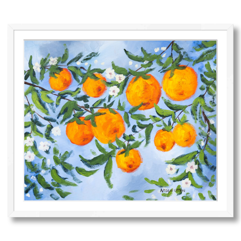A ready to hang, framed giclee art print featuring a painting of oranges on a tree with white flowers and a blue sky background by Arden Upton from her Orangerie Collection. Art for Gallery walls, kitchens, bright and happy spaces