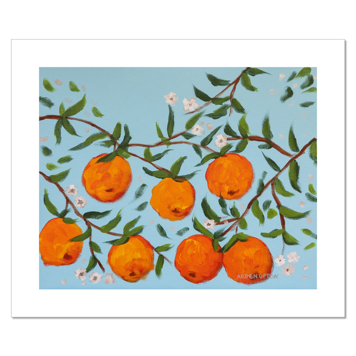 A ready to hang, framed giclee art print featuring a painting of oranges on a tree with white flowers and a blue sky background by Arden Upton from her Orangerie Collection. Art for Gallery walls, kitchens, bright and happy spaces