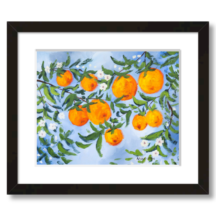 A ready to hang, framed giclee art print featuring a painting of oranges on a tree with white flowers and a blue sky background by Arden Upton from her Orangerie Collection. Art for Gallery walls, kitchens, bright and happy spaces