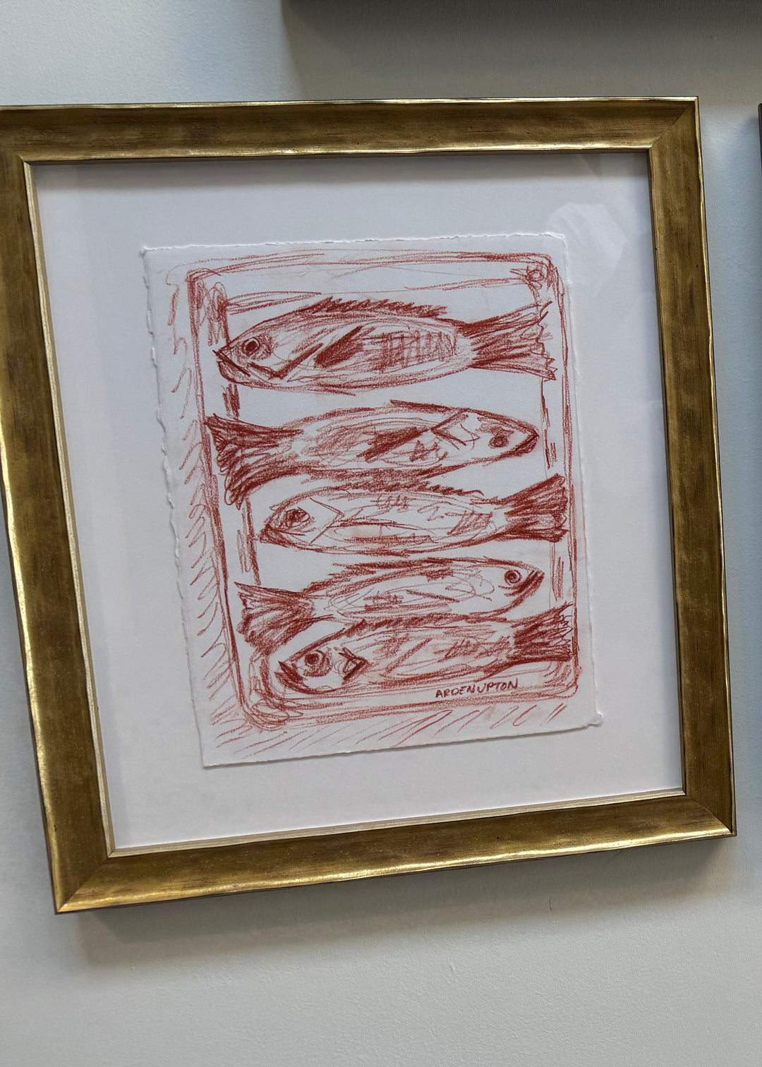  sketch from Southern Artist Arden Upton's Frank's Table Collection of five red fish lined up on a baking pan matted and framed in a gold textured frame. Great for kitchens and breakfast nooks, as well as gallery walls and paired with other pieces from this collection. 