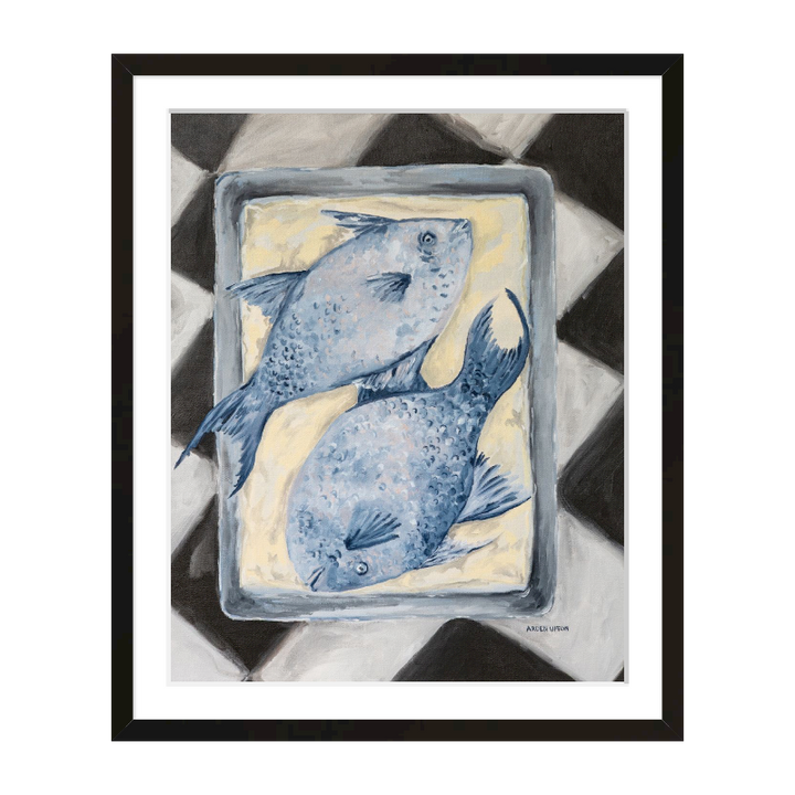 Coastal-inspired Blue Fish painting framed in black frame – two blue fish on a tray sitting on a black and white checkered surface. A fine art print from the Frank’s Table collection, perfect for dining room or kitchen décor