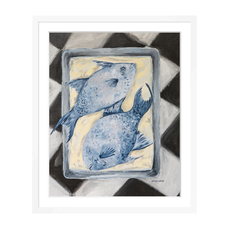 Coastal-inspired Blue Fish painting framed in white frame– two blue fish on a tray sitting on a black and white checkered surface. A fine art print from the Frank’s Table collection, perfect for dining room or kitchen décor