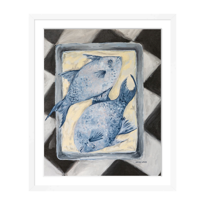 Coastal-inspired Blue Fish painting framed in white frame– two blue fish on a tray sitting on a black and white checkered surface. A fine art print from the Frank’s Table collection, perfect for dining room or kitchen décor