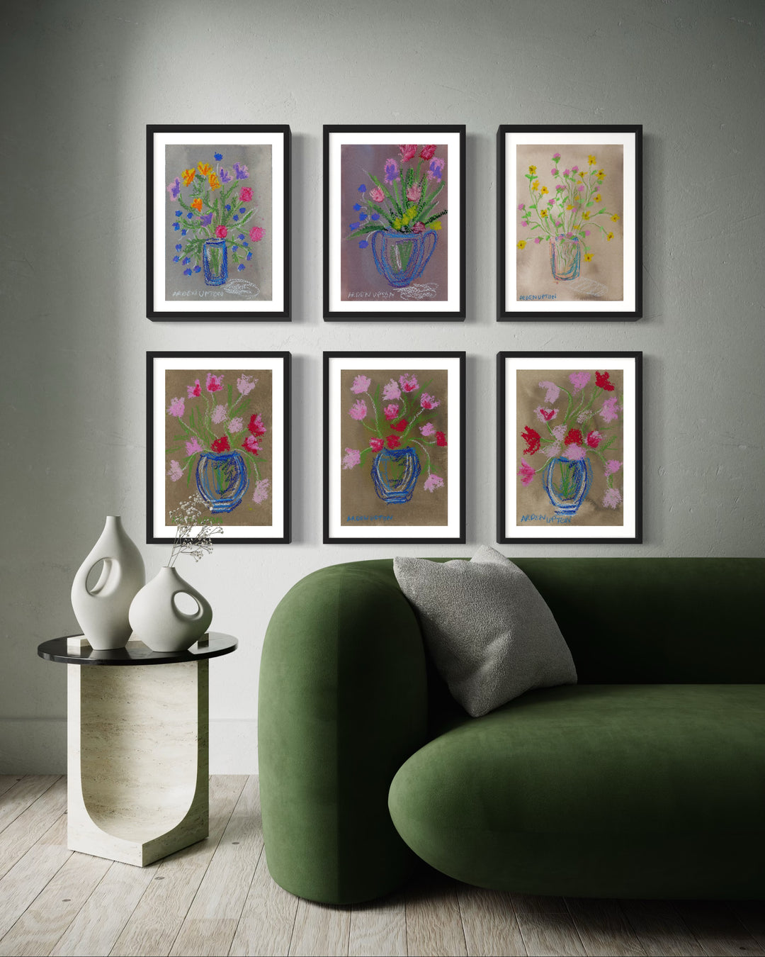 Curated vibrant gallery wall of mixed media floral, botanical giclée prints from Arden Upton's Flowers that last Collection styled with green couch and vases for bright happy space