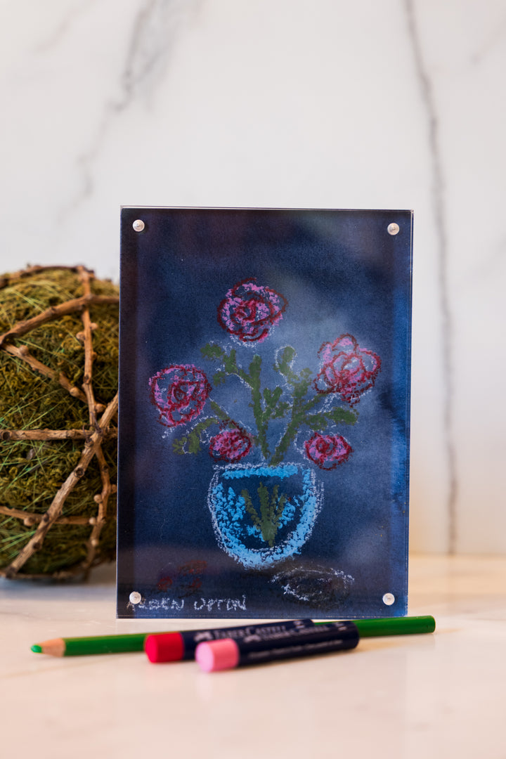 Red and Pink flowers in a blue vase on a navy background with green leaves from Arden Upton's Flowers that Last Collection  Framed in an acrylic block and staged with art supplies and greenery. These make great teachers gifts and hostess gifts and are beautiful. 