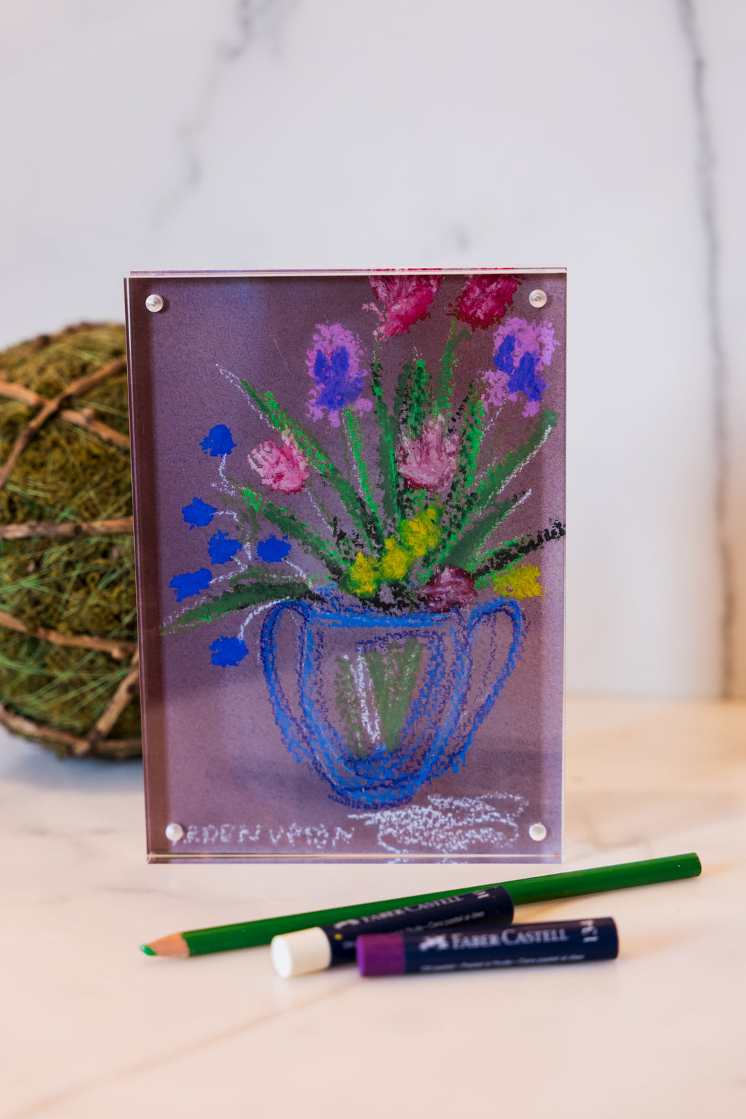 Red, Purple, yellow and Pink flowers in a blue vase on a pinkish background with green leaves from Arden Upton's Flowers that Last Collection  Framed in an acrylic block and staged with art supplies and greenery. These make great teachers gifts and hostess gifts and are beautiful. 