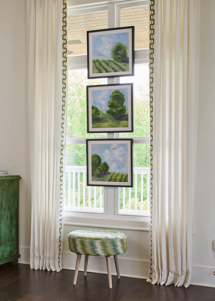 Framed green landscape paintings with blue skies from the Blue Skies Collection by Arden Upton, styled as a gallery wall in a bright living room. Original artwork and giclée fine art prints perfect for living rooms, hallways, staircases, or gifting