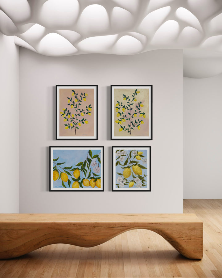 4 museum-quality fine art giclée prints of lemon trees, featuring vibrant yellow lemons on a lemon tree with green leaves against a pink and yellow background, and 2 others with blue backgrounds and lemons up close, all are a part of Arden Upton's Lemonade Series and styled here in a bright room