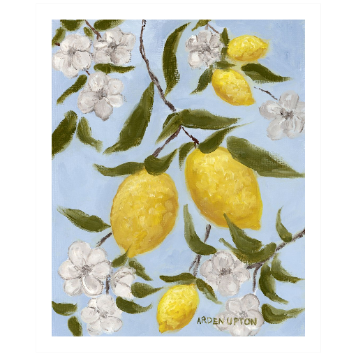A framed art print featuring a painting from Arden Upton's Lemonade Collection of lemons , leaves and white floral elements against a blue background, with a white mat and black frame.