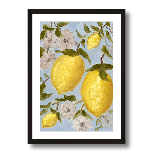 A framed art print featuring a painting from Arden Upton's Lemonade Collection of lemons , leaves and white floral elements against a blue background, with a white mat and black frame.