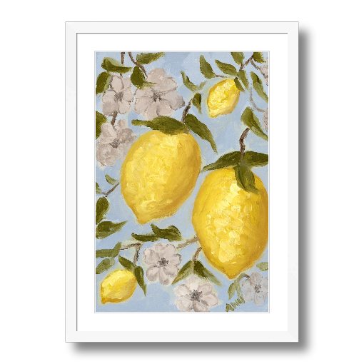 A framed art print featuring a painting from Arden Upton's Lemonade Collection of lemons , leaves and white floral elements against a blue background, with a white mat and black frame.
