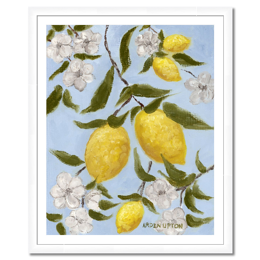 A framed art print featuring a painting from Arden Upton's Lemonade Collection of lemons , leaves and white floral elements against a blue background, with a white mat and black frame.