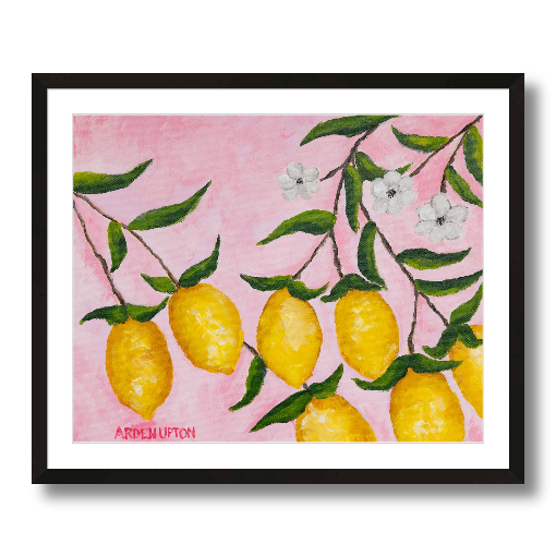 A framed art print featuring a painting from Arden Upton's Lemonade Collection of lemons, leaves and white floral elements against a pink background