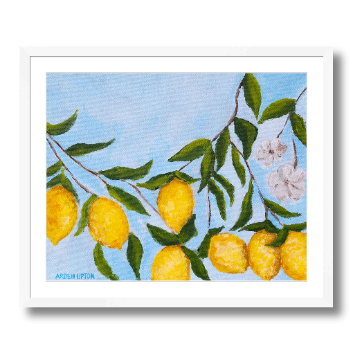A framed art print featuring a painting from Arden Upton's Lemonade Collection of lemons , leaves and white floral elements against a blue background, with a white mat and black frame.