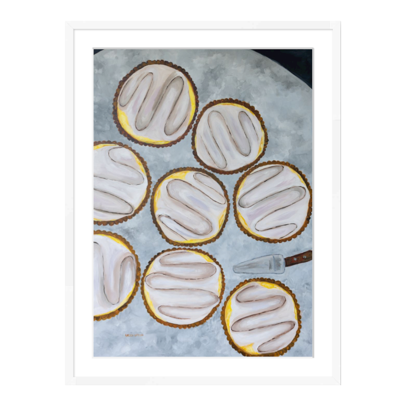 A painting by Southern artist Arden Upton of eight beautifully baked lemon tarts on a table with a tart server. Print is framed in a white frame