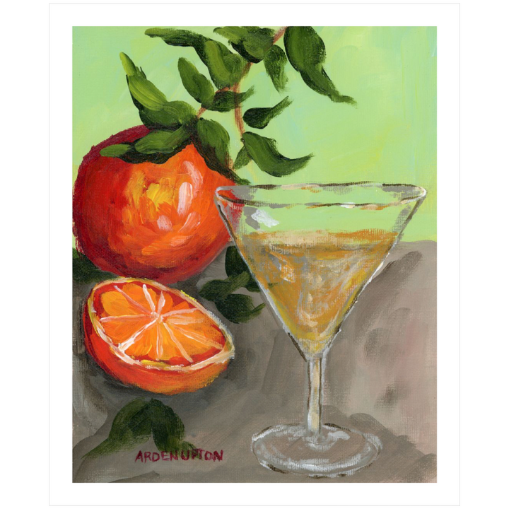 An unframed painting of a yellow Martini and an orange and a half on an orange tree stem sitting. on grey table painted in bold orange, red and green colors, with great texture and detail great for for kitchens, pantries, dining rooms, and entertaining spaces