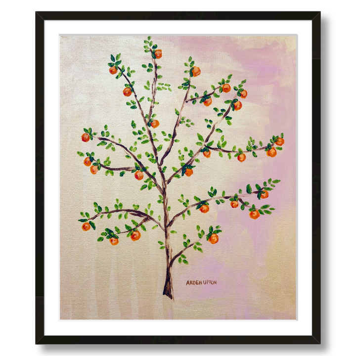 A framed, ready to hang giclee print of an orange tree with green leaves and ripe oranges on a pink and yellow background. An original painting from Arden Upton's Orangerie Collection. Great for decorating walls in kitchens and bright spaces. Buy one or multiple from the collection