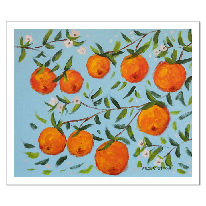 A ready to hang, framed giclee art print featuring a painting of oranges on a tree with white flowers and a blue sky background by Arden Upton from her Orangerie Collection. Art for Gallery walls, kitchens, bright and happy spaces
