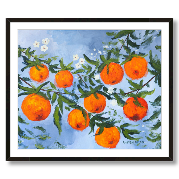 A ready to hang, framed giclee art print featuring a painting of oranges on a tree with white flowers and a blue sky background by Arden Upton from her Orangerie Collection. Art for Gallery walls, kitchens, bright and happy spaces