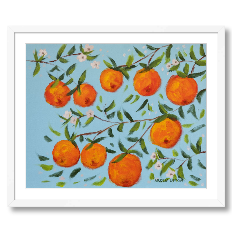 A ready to hang, framed giclee art print featuring a painting of oranges on a tree with white flowers and a blue sky background by Arden Upton from her Orangerie Collection. Art for Gallery walls, kitchens, bright and happy spaces
