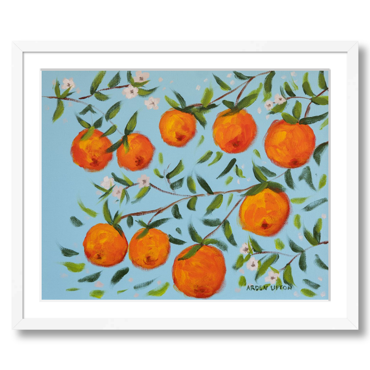 A ready to hang, framed giclee art print featuring a painting of oranges on a tree with white flowers and a blue sky background by Arden Upton from her Orangerie Collection. Art for Gallery walls, kitchens, bright and happy spaces