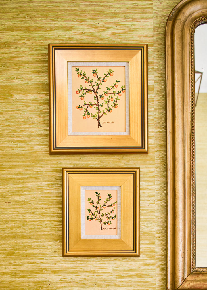Pair of paintings in an entryway featuring orange citrus artwork from the Orangerie Collection - a mix of original paintings and giclée fine art prints in vibrant, happy colors perfect for summer home decor. Great for pairing or displaying solo.