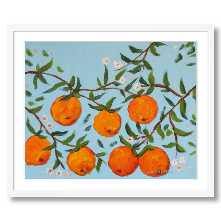 A ready to hang, framed giclee art print featuring a painting of oranges on a tree with white flowers and a blue sky background by Arden Upton from her Orangerie Collection. Art for Gallery walls, kitchens, bright and happy spaces