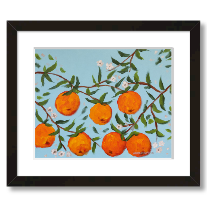 A ready to hang, framed giclee art print featuring a painting of oranges on a tree with white flowers and a blue sky background by Arden Upton from her Orangerie Collection. Art for Gallery walls, kitchens, bright and happy spaces