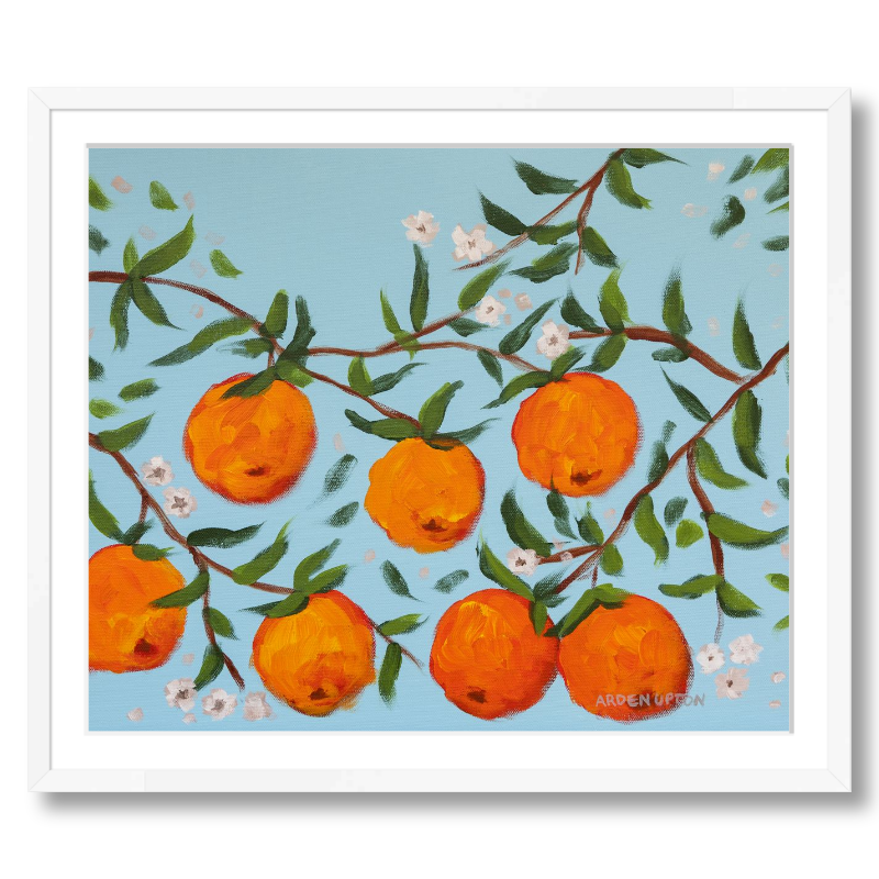 A ready to hang, framed giclee art print featuring a painting of oranges on a tree with white flowers and a blue sky background by Arden Upton from her Orangerie Collection. Art for Gallery walls, kitchens, bright and happy spaces