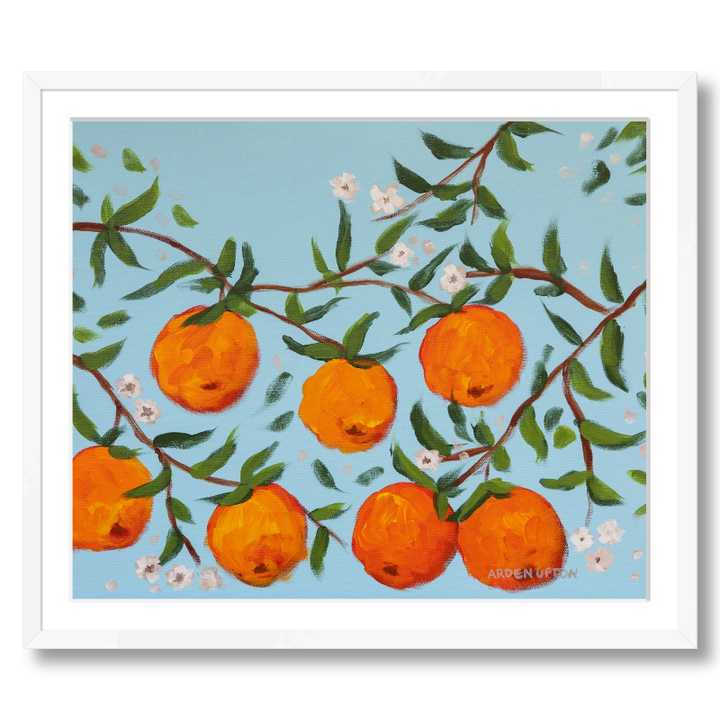 A ready to hang, framed giclee art print featuring a painting of oranges on a tree with white flowers and a blue sky background by Arden Upton from her Orangerie Collection. Art for Gallery walls, kitchens, bright and happy spaces