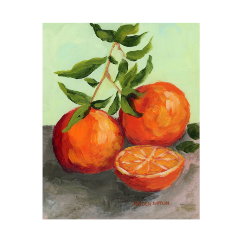 Easy hang dining room art collection – foodie gallery wall citrus paintings in black and white frames for stylish dining or kitchen décor. Painting shows two and a half beautifully detailed oranges with a stem of greenery