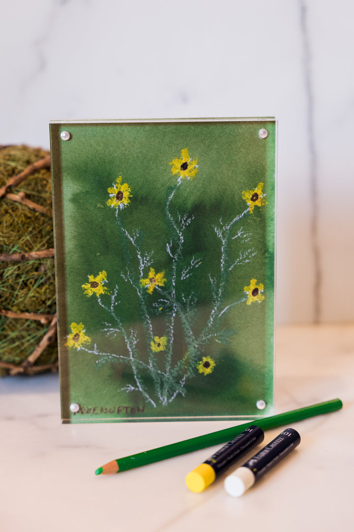 Yellow wildflowers on a green background from Arden Upton's Flowers that Last Collection  Framed in an acrylic block and staged with art supplies and greenery. These make great teachers gifts and hostess gifts and are beautiful. 