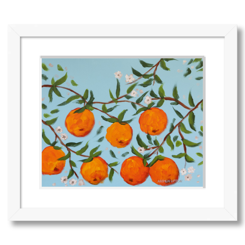 A ready to hang, framed giclee art print featuring a painting of oranges on a tree with white flowers and a blue sky background by Arden Upton from her Orangerie Collection. Art for Gallery walls, kitchens, bright and happy spaces