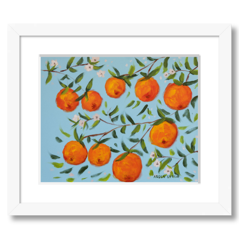 A ready to hang, framed giclee art print featuring a painting of oranges on a tree with white flowers and a blue sky background by Arden Upton from her Orangerie Collection. Art for Gallery walls, kitchens, bright and happy spaces