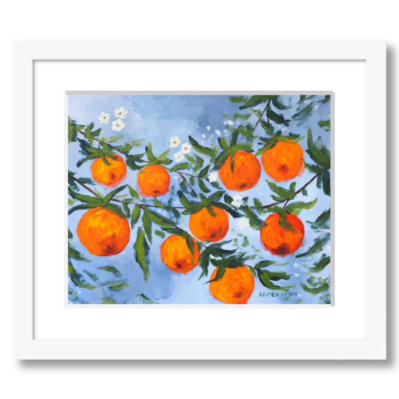 A ready to hang, framed giclee art print featuring a painting of oranges on a tree with white flowers and a blue sky background by Arden Upton from her Orangerie Collection. Art for Gallery walls, kitchens, bright and happy spaces